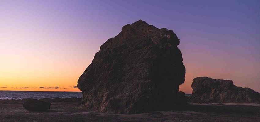 Una grande roccia su una spiaggia.